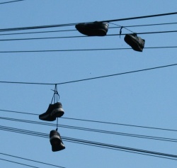 Two pairs of shoes slung over a telephone wire in Leeds