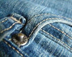 A pocket on a pair of denim jeans